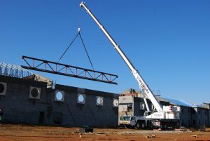 A Large Crane In Front Of A Building